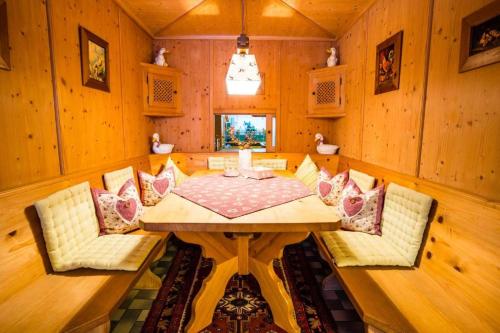 a dining room with a wooden table and chairs at Haus Lundsör-Barret by MoniCare in Seefeld in Tirol