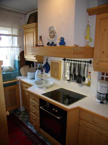 a kitchen with a sink and a stove top oven at Haus Lundsör-Barret by MoniCare in Seefeld in Tirol