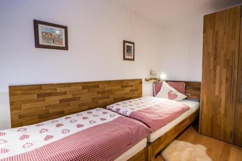 a small bedroom with a bed with pink sheets at Haus Lundsör-Barret by MoniCare in Seefeld in Tirol