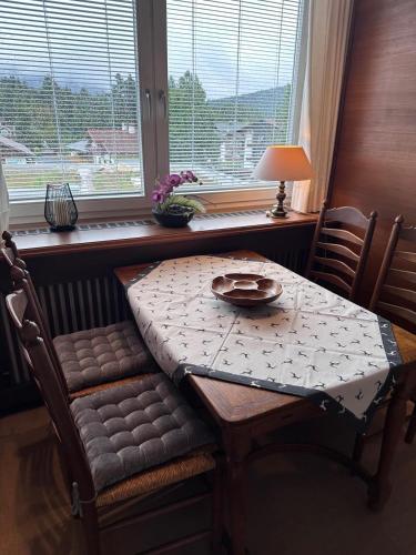 a table and chairs with a table and a window at Appartement ALEXANDRA by MoniCare in Seefeld in Tirol