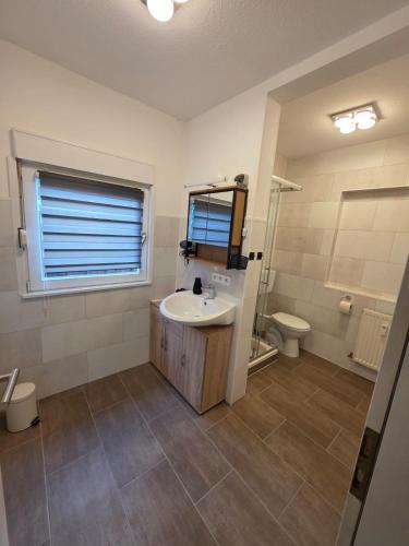 a bathroom with a sink and a toilet at Gundis Heidehus, Ferienhaus in Schneverdingen
