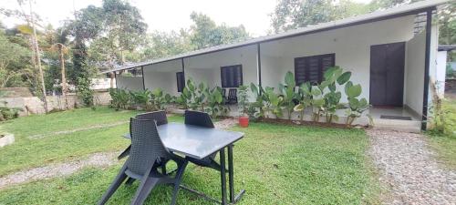 a table and chairs in front of a house at Tamarind Villa in Varkala