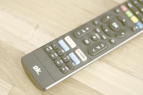 a remote control sitting on top of a wooden table at Appartement ALPINOVA by MoniCare in Reith bei Seefeld