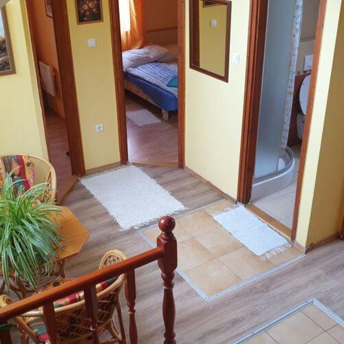 a room with a hallway with a door to a bedroom at Szabó Pince Vendégház in Balatonederics