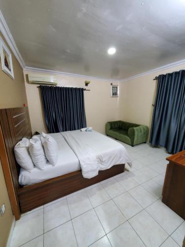 a hotel room with a bed and a couch at Romeo Suites & Apartment in Ipaja
