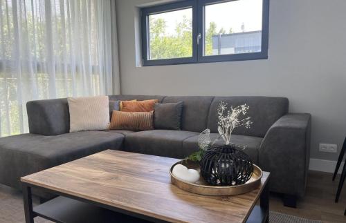 a living room with a couch and a table at Vakantiepark de Zeeuwse Parel - de Zeebries in Sint Maartensdijk