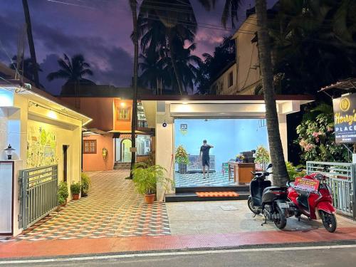 a red motorcycle parked in front of a house at Henry's Place in Calangute