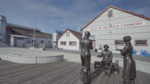 a statue of three people sitting on a bench in front of a building at Holiday Inn Vancouver Airport Richmond by IHG in Richmond