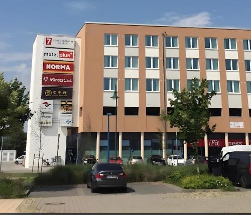 a car parked in a parking lot in front of a building at Nahe Airport Ber Maisonettewohnung in Schönefeld