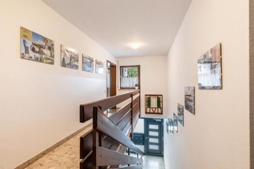 a staircase in a house with pictures on the walls at Apartment Am Wasen in Kirchheim unter Teck