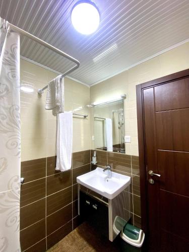 a bathroom with a sink and a mirror at Cascadia Apartments Kigali in Kigali
