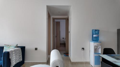 a kitchen with white walls and a white refrigerator at City Charm in Nairobi