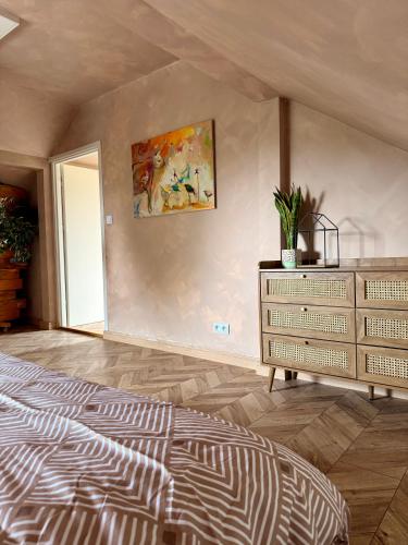 a bedroom with a bed and a dresser at Apartament pod miastem in Lanckorona