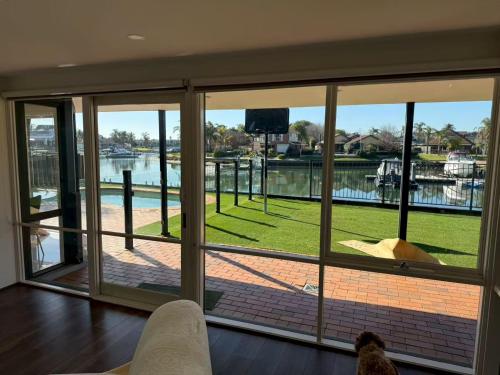 a room with a large window with a view of a body of water at 6-Bed Lake Escape for Families & Friends in Patterson Lakes