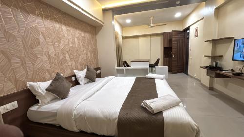 a bedroom with a large bed in a room at Hotel Prime Suites - Baner in Pune