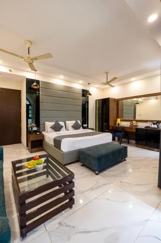 a bedroom with a bed and a living room at Hotel PK Residency Sector 18 Noida in Noida
