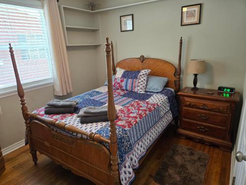 a bedroom with a bed and a dresser and a window at Hist Two Bedroom Home in Avondale Riverside Jacksonville in Jacksonville