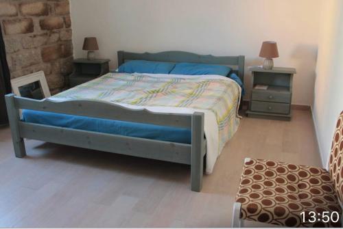 a bedroom with a bed and two night stands at PM 16 Via Frati de Addis in Aggius