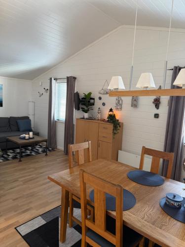 a dining room and living room with a table and chairs at Strand 18b in Grebbestad