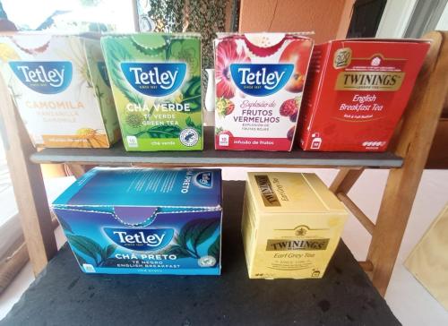 a shelf with several boxes of teazos andamines at Retiro dos Cedros - Quarto Vinhas in Fogueira