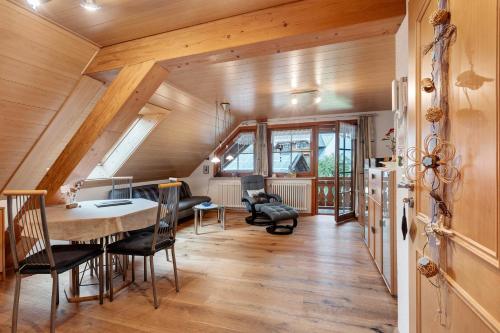 a dining room with a table and chairs in a house at Ferienwohnung Schweizer in Bernau im Schwarzwald