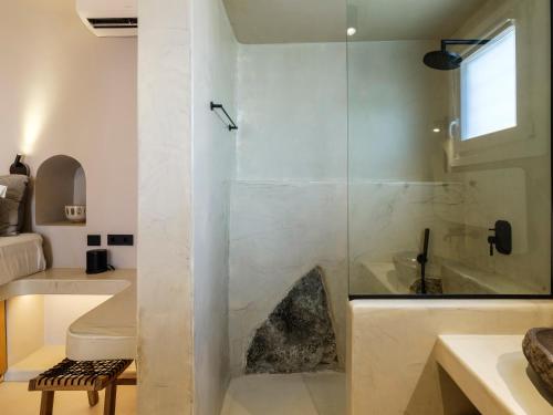 a bathroom with a glass shower and a sink at Jacuzzi Suite by Divalproperties-Mykonos in Megali Ammos