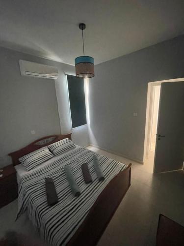 a bedroom with a large bed with four pillows at Azure Waves House in Voroklini