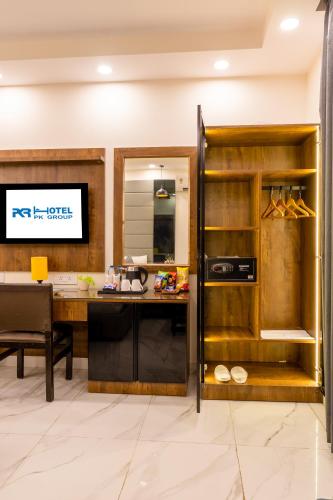 an open kitchen with a desk and a table at Hotel PK Residency Sector 18 Noida in Noida