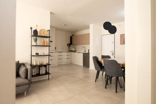 a kitchen and dining room with a table and chairs at Family Apartment By IsrApart in Ramat Gan