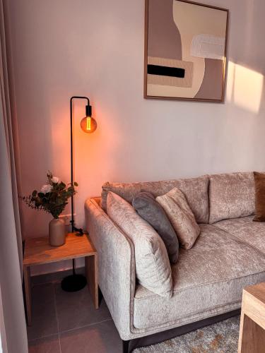 a living room with a couch and a lamp at Cozy & Stylish 1Bedroom Apartment in Limassol