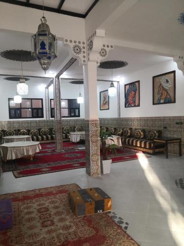 a room with tables and rugs on the walls at Auberge Kasbah Amoun in Taliouine