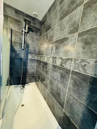 a bathroom with a shower and a bath tub at L'R Marin in Grand-Fort-Philippe