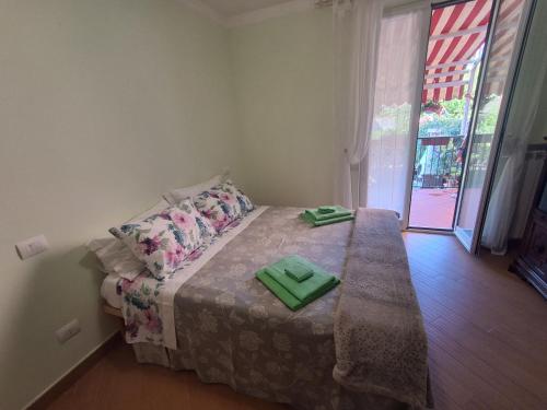 a bedroom with a bed with two green napkins on it at Imperiale in Sarzana