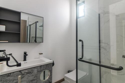 a bathroom with a sink and a glass shower at Rocky 39 in Grand-Baie