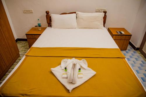 a bedroom with a bed with an elephant towel at Maison Blanche DK in Puducherry