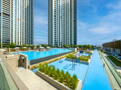 an overhead view of a large swimming pool with tall buildings at Dubai Mall Connection - Burj Views - Turf Balcony in Dubai