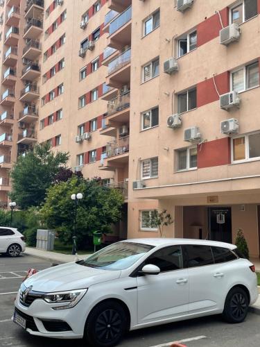 a white car parked in front of a building at Peppers Studio in Bucharest