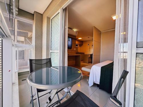 a small room with a glass table and a bed at The Expression Building - Setor Bueno - THP in Goiânia