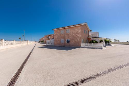 a building in the middle of a parking lot at Residence Horizont in Margherita di Savoia