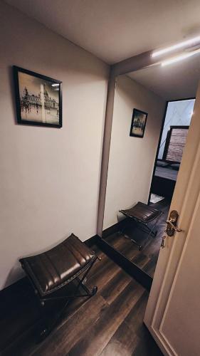 an empty room with two chairs and a mirror at Naavya by Jaiswal House in Kolkata