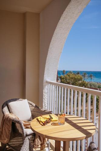 a table and a chair on a balcony with the ocean at ME Marbella by Meliá in Marbella