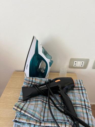 a iron sitting on top of a table at Kings Castle Sea View Apartments in Orikum