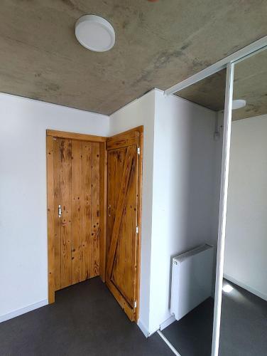 a room with a wooden door and a ceiling at Chalúpky pod Viaduktom in Telgárt