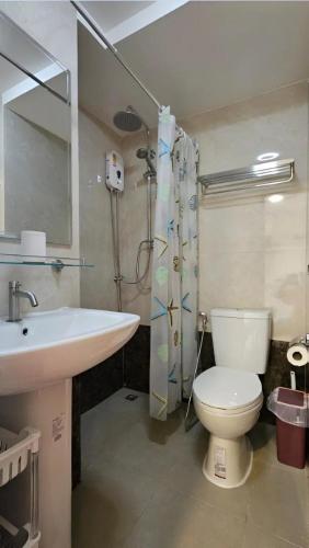 a bathroom with a toilet and a sink and a mirror at Nature View Residence in Mai Khao Beach