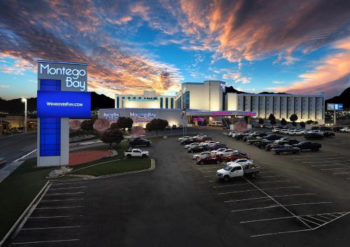 a parking lot with cars parked in front of a hotel at Montego Bay Resort Casino by Peppermill Resorts in West Wendover