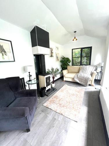 a living room with a couch and a rug at Storeybook cottage in Oswestry