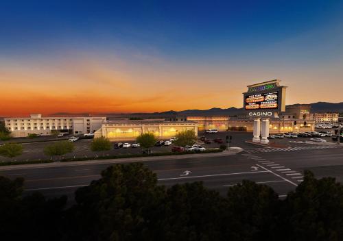 a parking lot with a sign in front of a building at Rainbow Hotel Casino by Peppermill Resorts in West Wendover