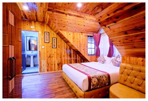 a bedroom with a bed in a log cabin at Hotel Zambala Retreat & Spa Darjeeling in Darjeeling