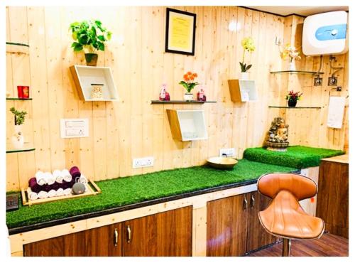 a kitchen with a green counter top with a chair at Hotel Zambala Retreat & Spa Darjeeling in Darjeeling