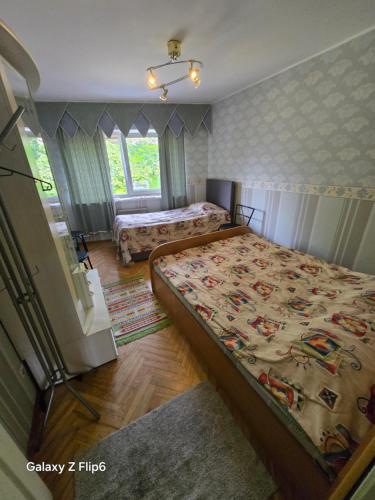 a bedroom with two beds and a window at Willa Ranna Resort in Pärnu